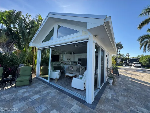 a view of a house with porch and garden