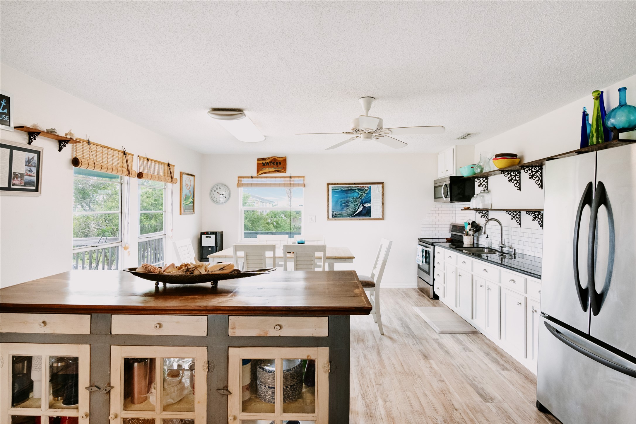 88 Bay Street Port O'Connor, TX 77982 - Photo 11 of 23 a kitchen with stainless steel appliances wooden floor and large window