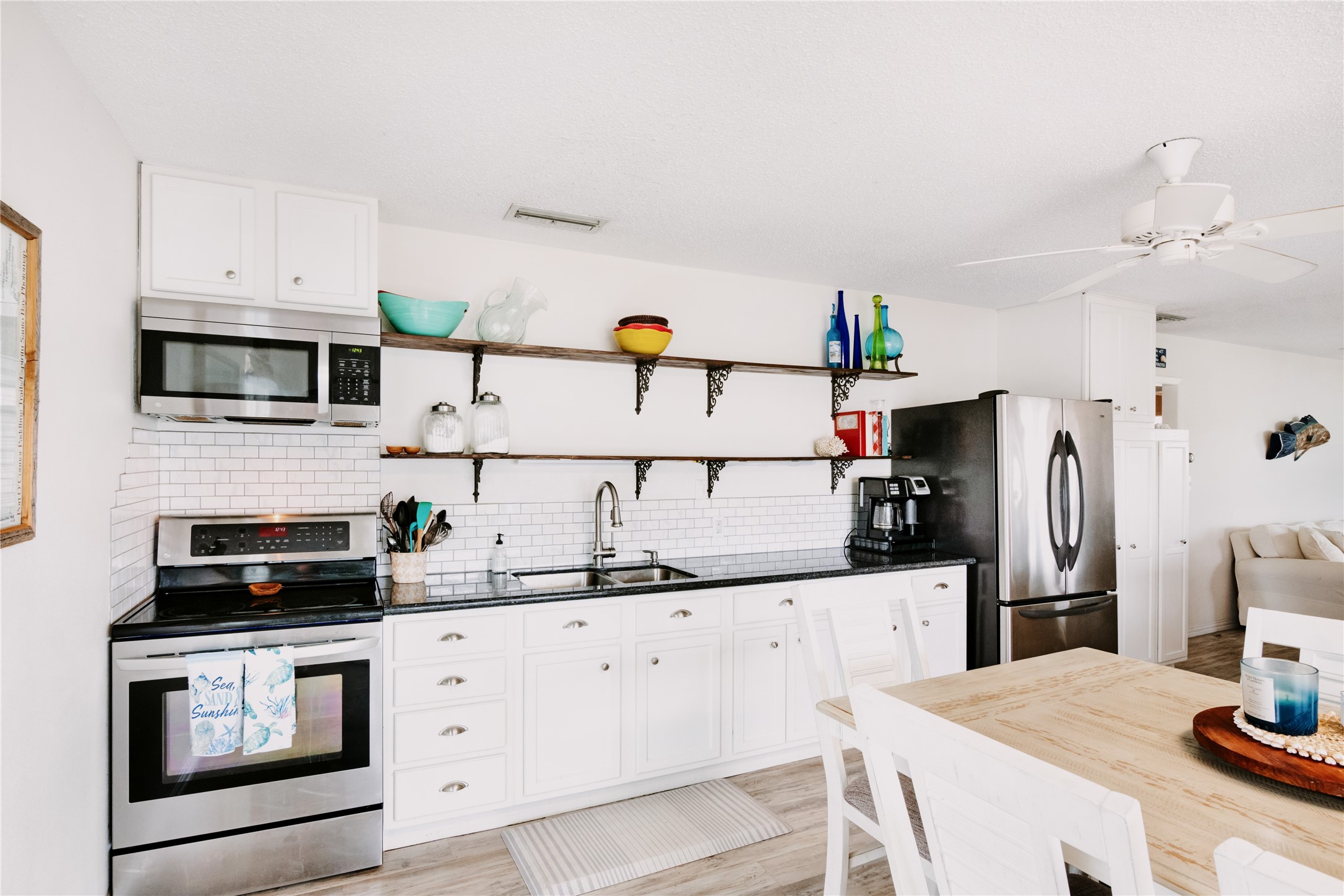 88 Bay Street Port O'Connor, TX 77982 - Photo 10 of 23 a kitchen with granite countertop a sink stove and refrigerator