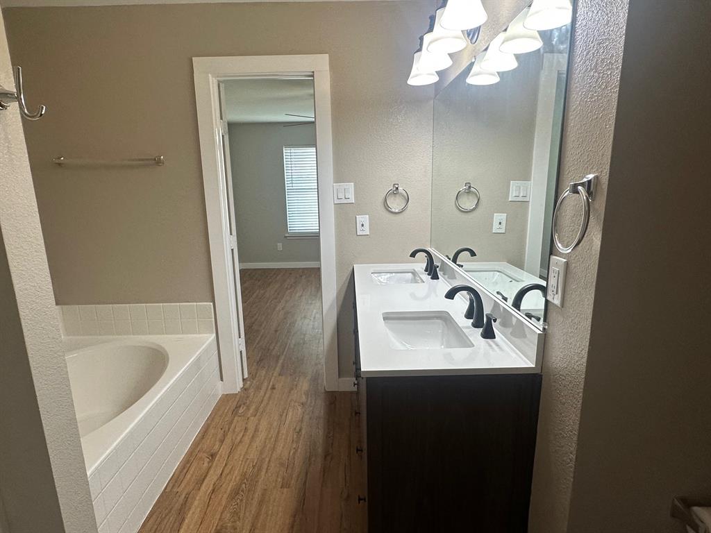 203 Shadow Bend Drive Red Oak, TX 75154 - Photo 15 of 15 a bathroom with a sink a mirror and a bathtub