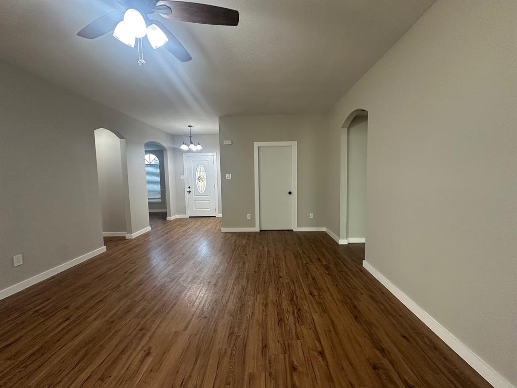203 Shadow Bend Drive Red Oak, TX 75154 - Photo 5 of 15 a view of a room with wooden floor and a ceiling fan