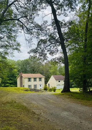 a front view of house with yard and green space