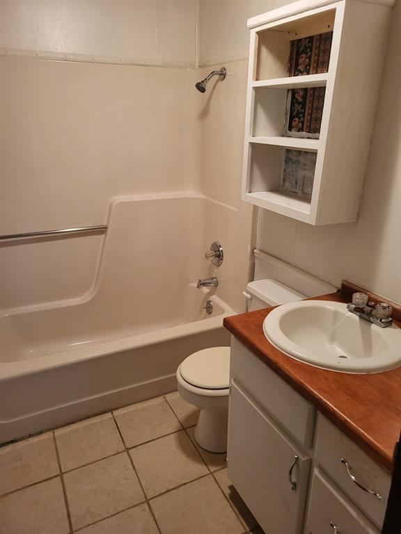 375 North Austin Street Avery, TX 75554 - Photo 10 of 11 a bathroom with a sink a toilet and shower