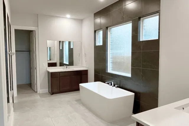 a bathroom with a glass shower door and a sink