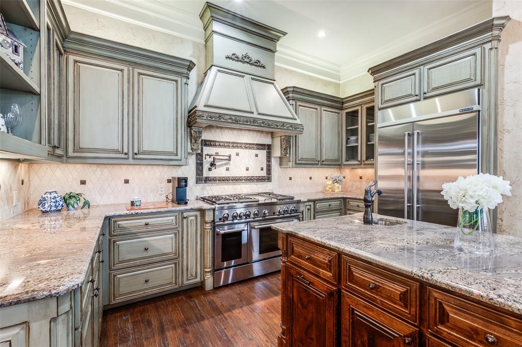 141 Waters Edge Way Oak Point, TX 75068 - Photo 14 of 25 a kitchen with stainless steel appliances granite countertop a stove and a sink