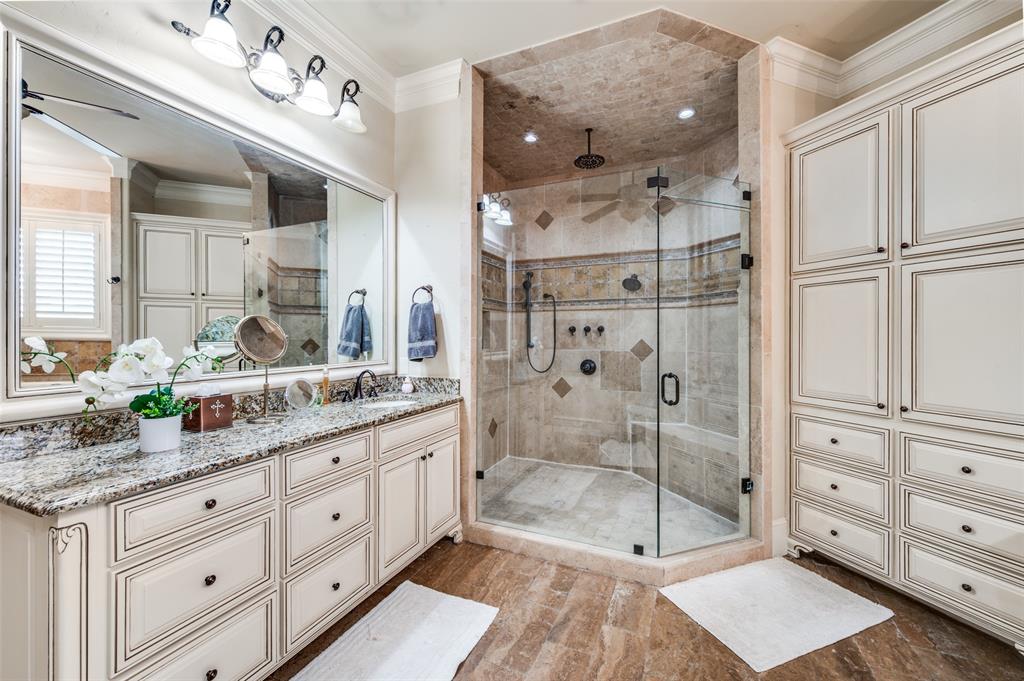 141 Waters Edge Way Oak Point, TX 75068 - Photo 16 of 25 a bathroom with a granite countertop sink mirror and shower