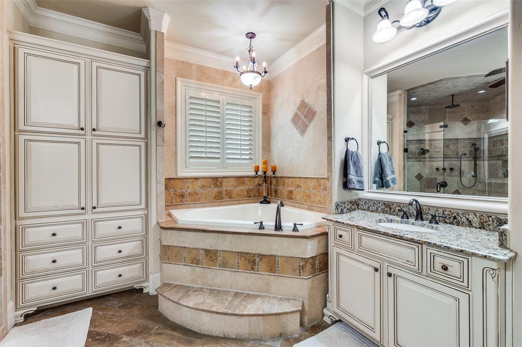141 Waters Edge Way Oak Point, TX 75068 - Photo 17 of 25 a bathroom with a tub a sink and mirror