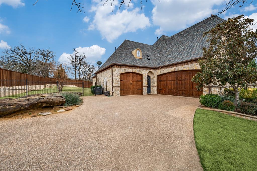 141 Waters Edge Way Oak Point, TX 75068 - Photo 22 of 25 a view of a house with a yard and garage