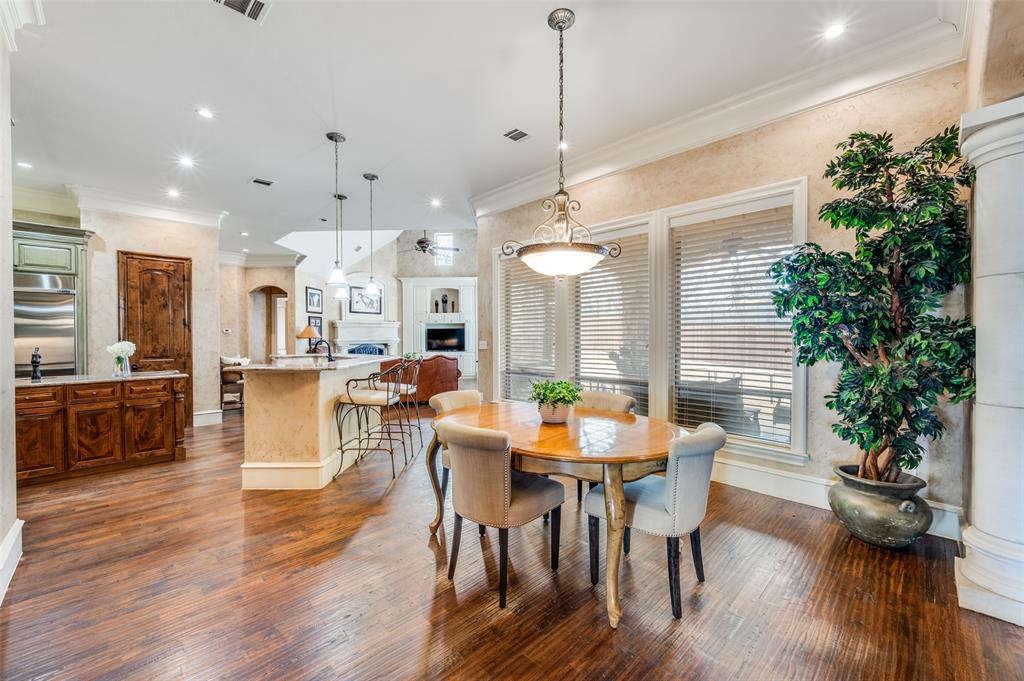 141 Waters Edge Way Oak Point, TX 75068 - Photo 10 of 25 a view of a dining room and livingroom with furniture wooden floor a chandelier