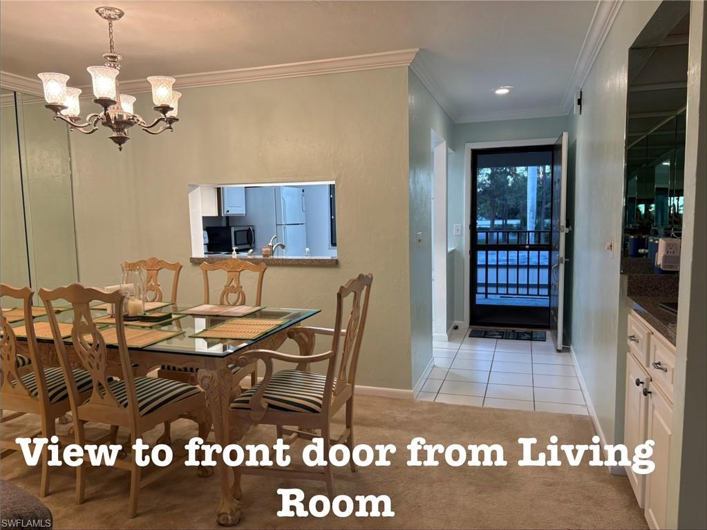 5841 Rattlesnake Hammock Road, Unit I203 Naples, FL 34113 - Photo 3 of 24 a view of a dining room and a rug