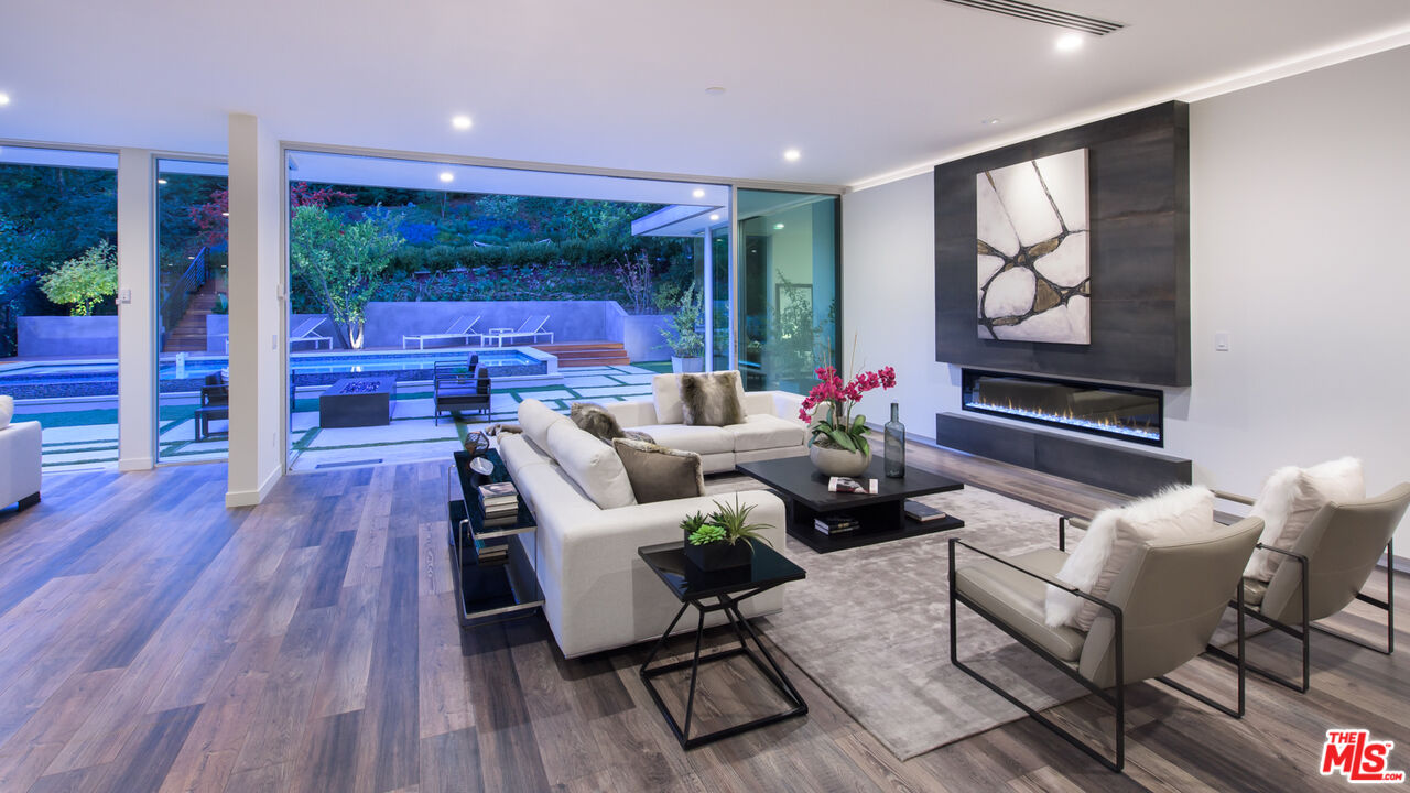 2213 Roscomare Road Los Angeles, CA 90077 - Photo 12 of 39 a living room with furniture a wooden floor and next to a window