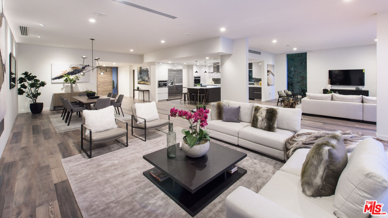 2213 Roscomare Road Los Angeles, CA 90077 - Photo 14 of 39 a living room with furniture kitchen view and a flat screen tv