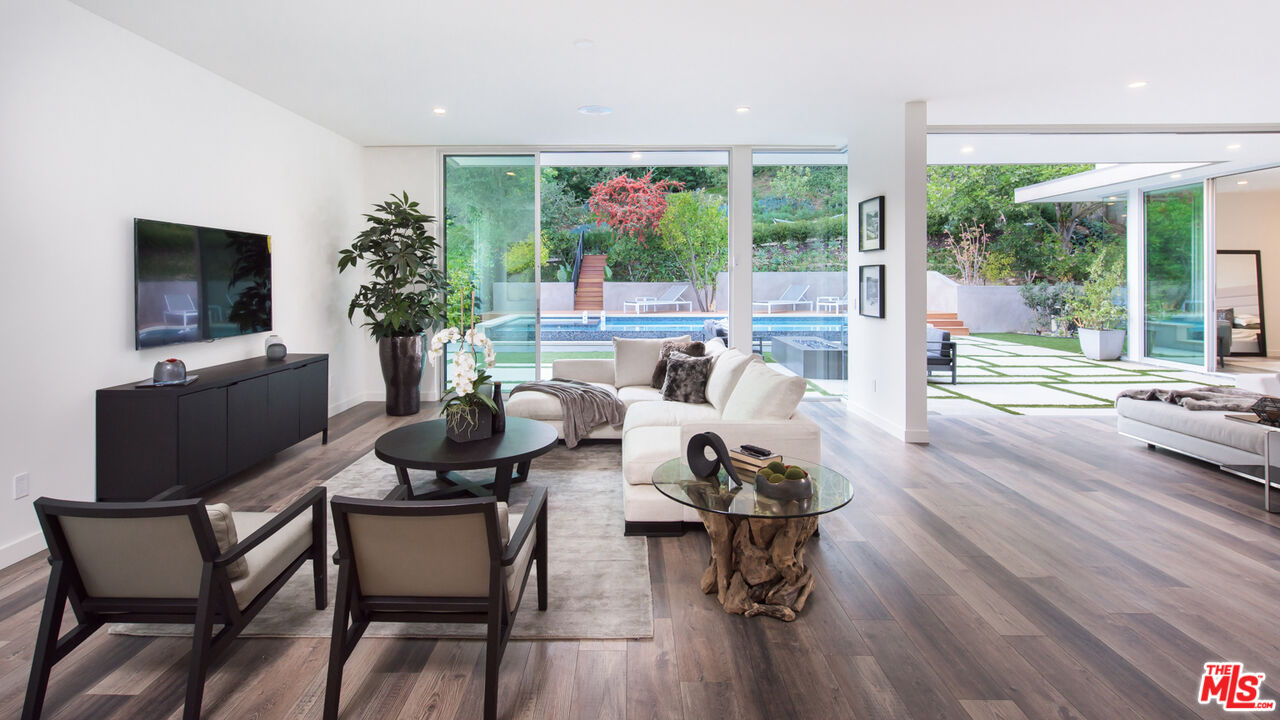 2213 Roscomare Road Los Angeles, CA 90077 - Photo 16 of 39 a living room with furniture and a flat screen tv
