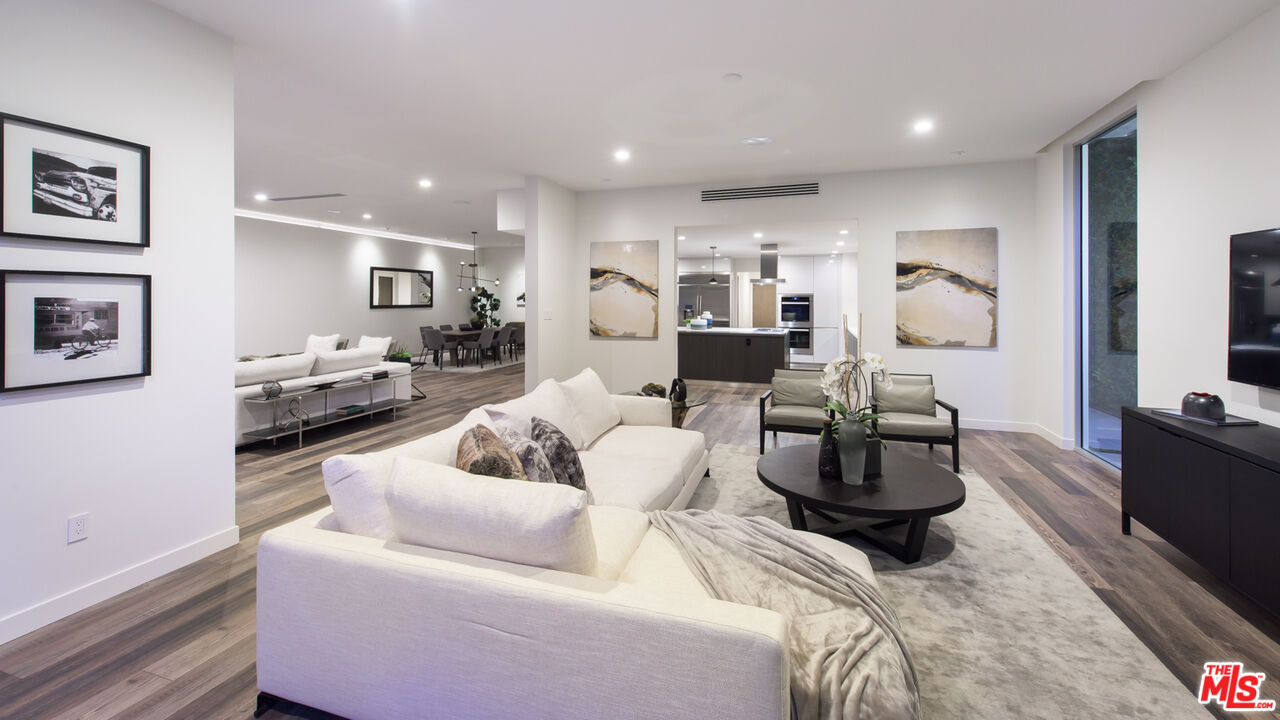 2213 Roscomare Road Los Angeles, CA 90077 - Photo 18 of 39 a living room with furniture and a flat screen tv