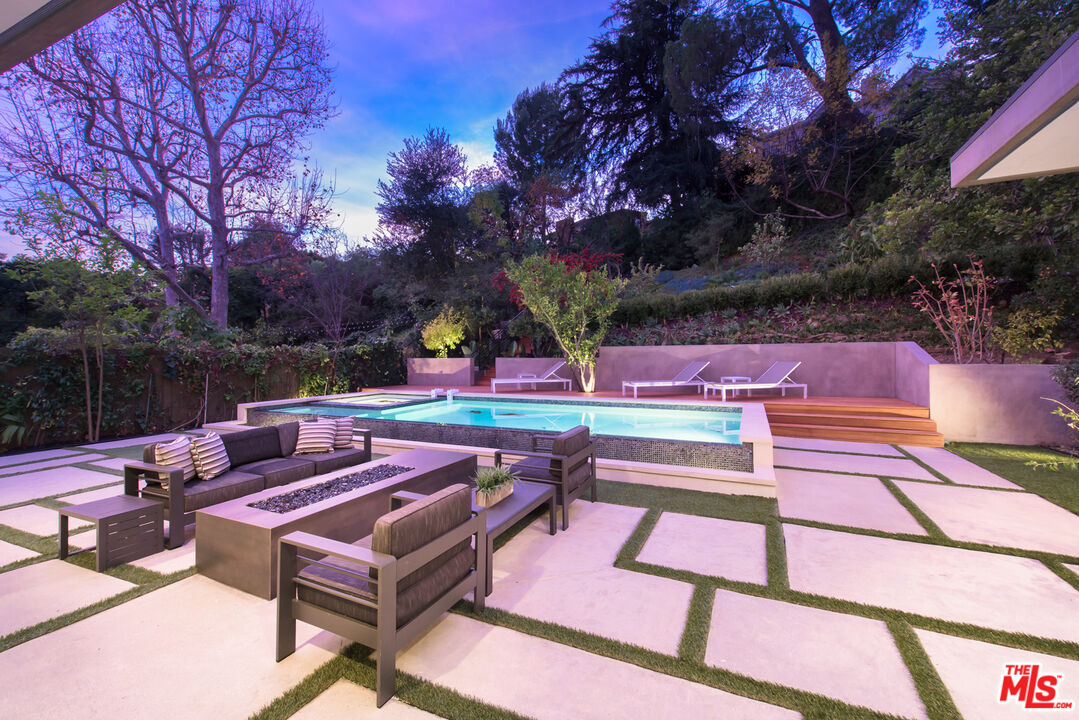 2213 Roscomare Road Los Angeles, CA 90077 - Photo 19 of 39 a backyard of a house with barbeque oven table and chairs