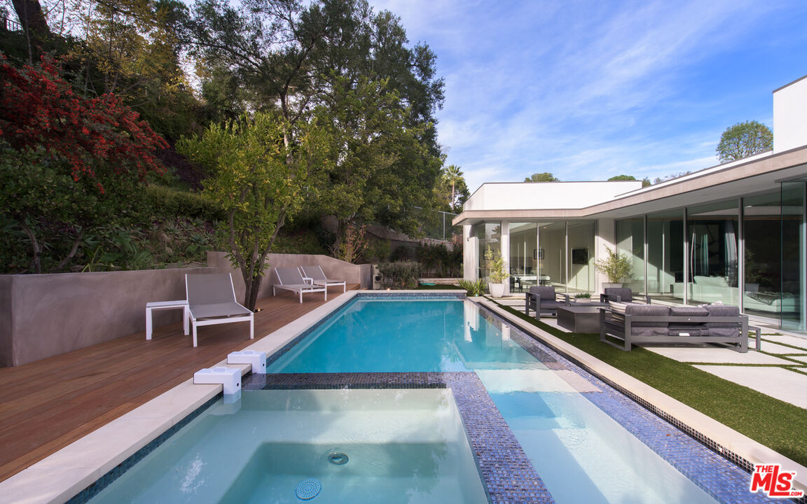 2213 Roscomare Road Los Angeles, CA 90077 - Photo 27 of 39 a view of a patio with swimming pool table and chairs