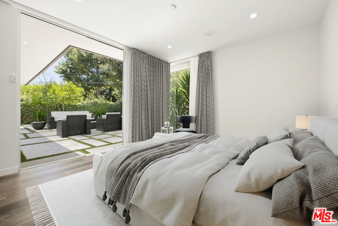 2213 Roscomare Road Los Angeles, CA 90077 - Photo 29 of 39 a bedroom with a bed and a large window