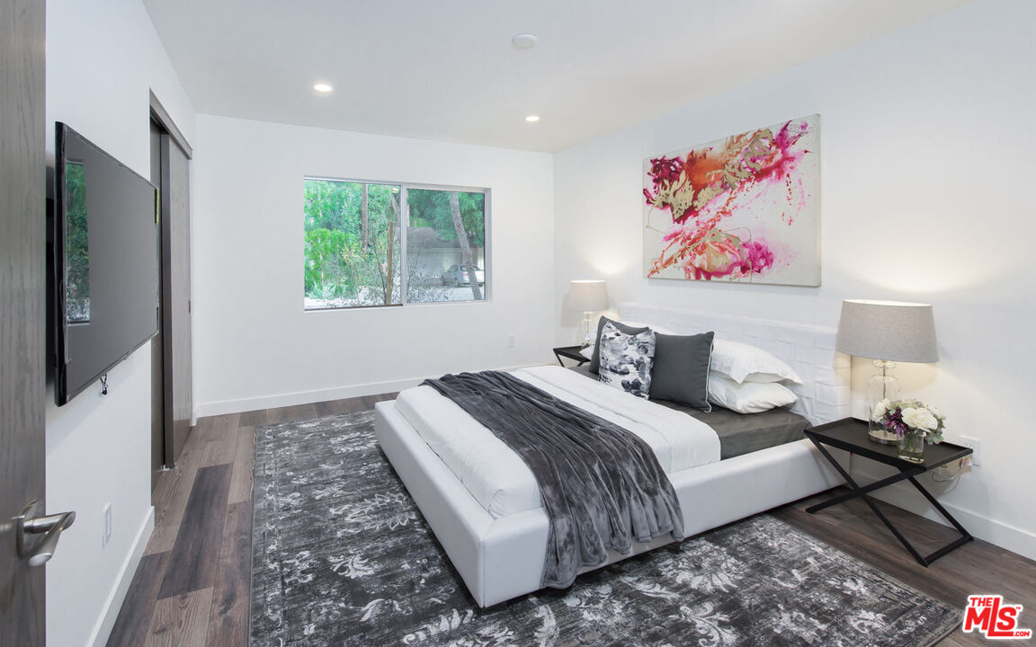 2213 Roscomare Road Los Angeles, CA 90077 - Photo 35 of 39 a bedroom with bed and a window