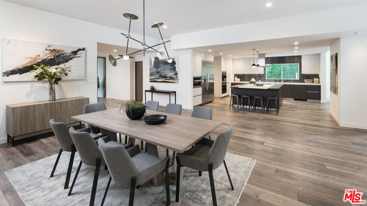 2213 Roscomare Road Los Angeles, CA 90077 - Photo 5 of 39 a view of a dining room with furniture and wooden floor