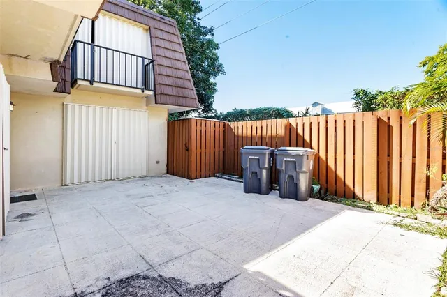 a view of a roof deck with wooden fence and floor