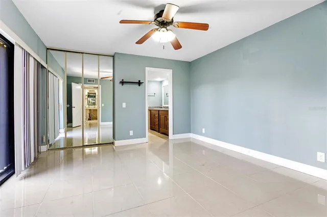 an empty room with fan and entrance