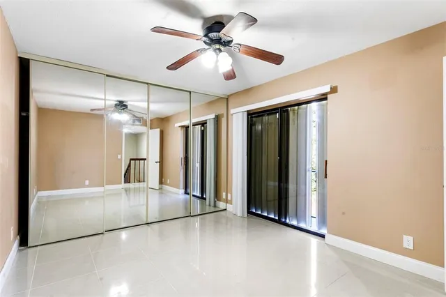a view of an empty room with a ceiling fan