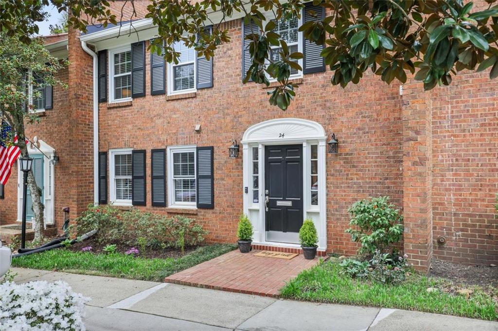 4620 Wieuca Road Northeast, Unit 24 Atlanta, GA 30342 - Photo 1 of 1 a front view of a house with garden