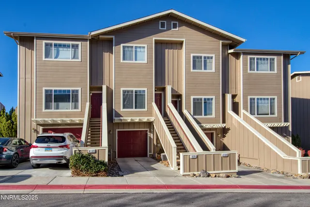 a front view of residential houses with stairs