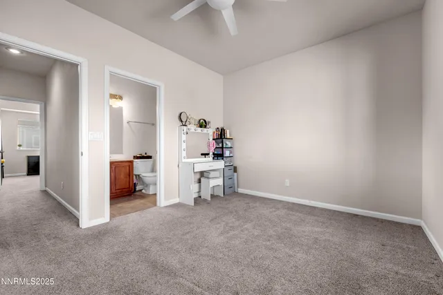 a bathroom with a granite countertop sink a toilet and a mirror