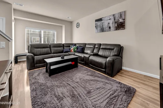 a living room with furniture and a rug