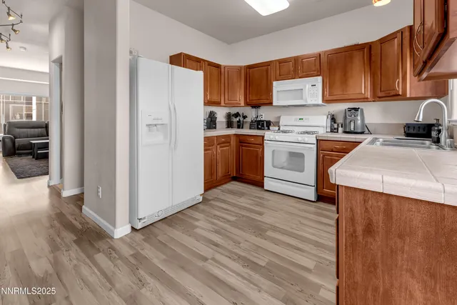 a kitchen with a refrigerator stove top oven and sink