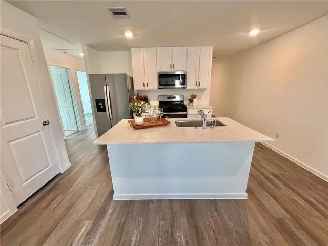 a room with wooden floors and wooden cabinets