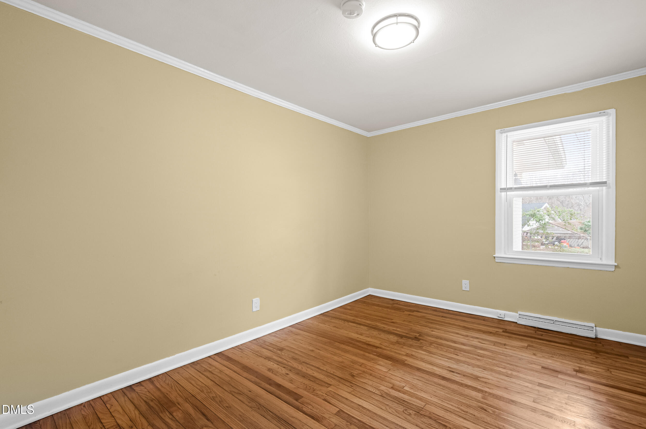 401 Moline Street Durham, NC 27707 - Photo 11 of 20 an empty room with wooden floor and windows