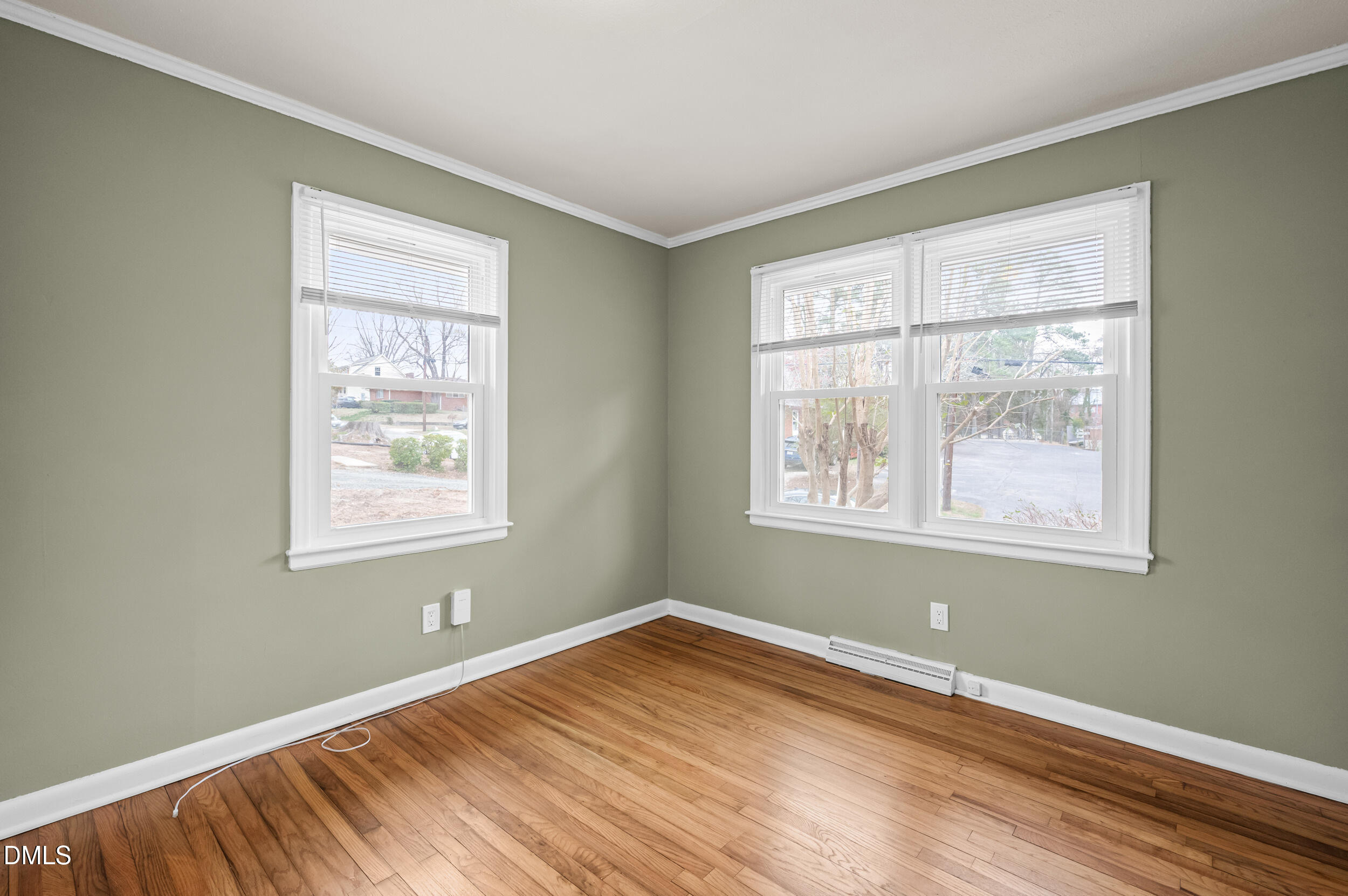 401 Moline Street Durham, NC 27707 - Photo 14 of 20 a view of an empty room with wooden floor and a window