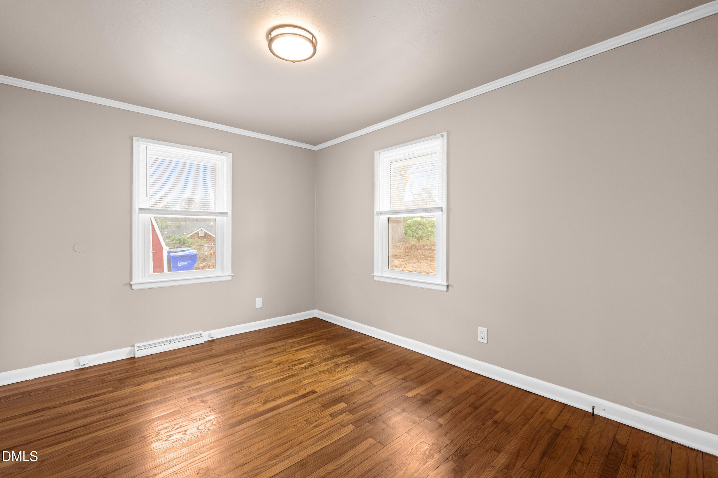 401 Moline Street Durham, NC 27707 - Photo 16 of 20 an empty room with wooden floor and windows