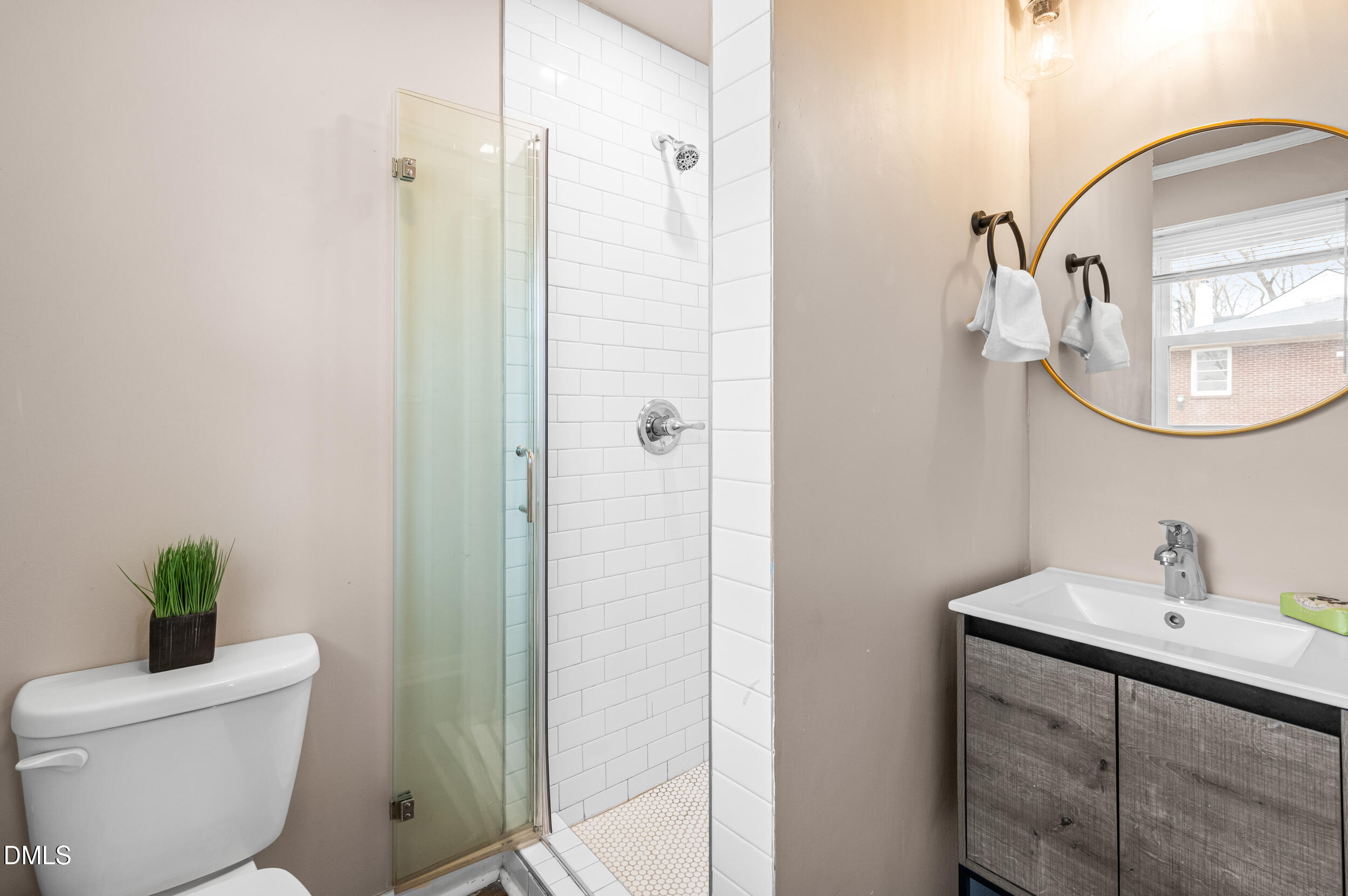 401 Moline Street Durham, NC 27707 - Photo 17 of 20 a bathroom with a toilet a sink and mirror