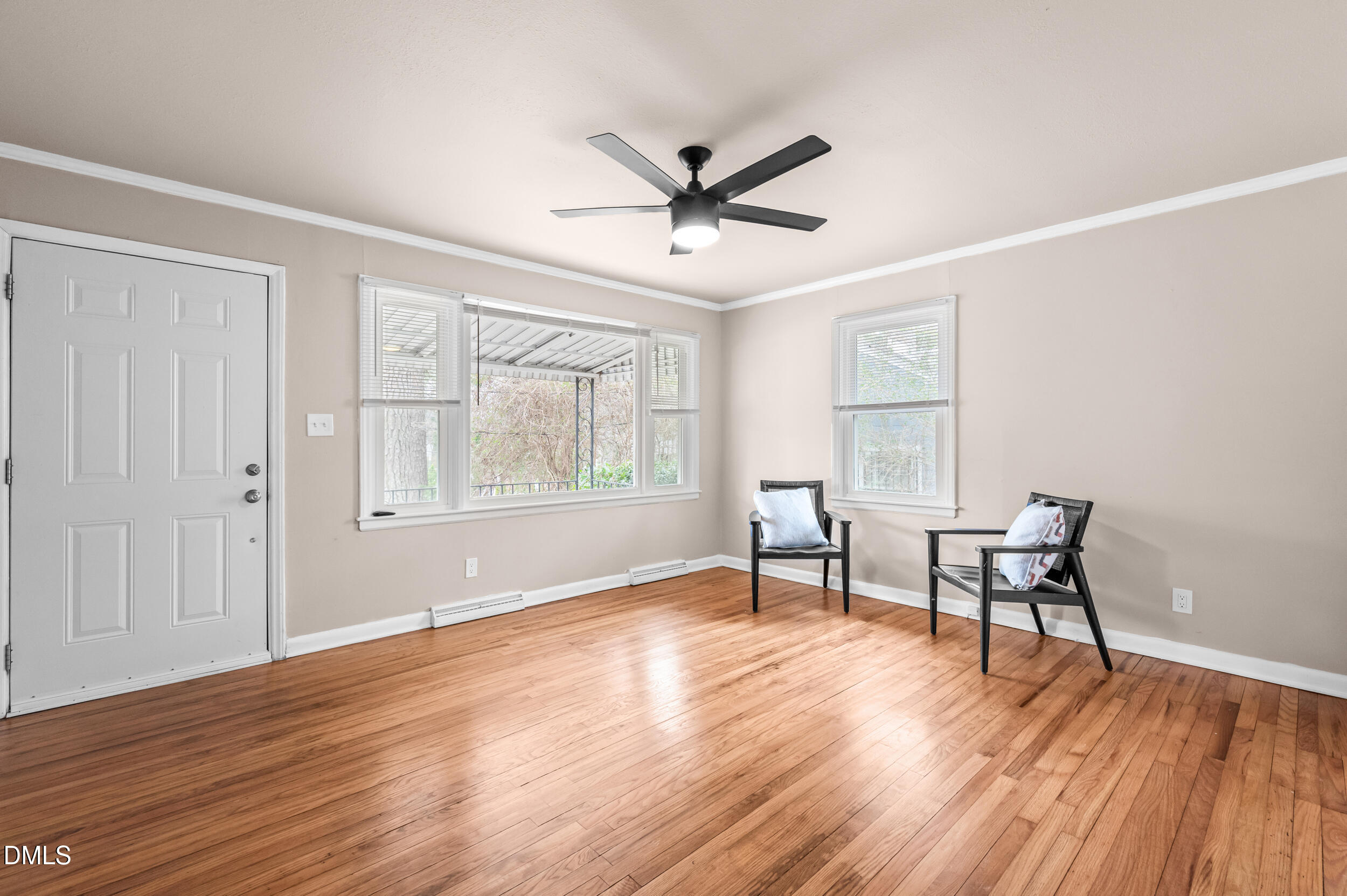 401 Moline Street Durham, NC 27707 - Photo 4 of 20 a view of a livingroom with wooden floor and a ceiling fan