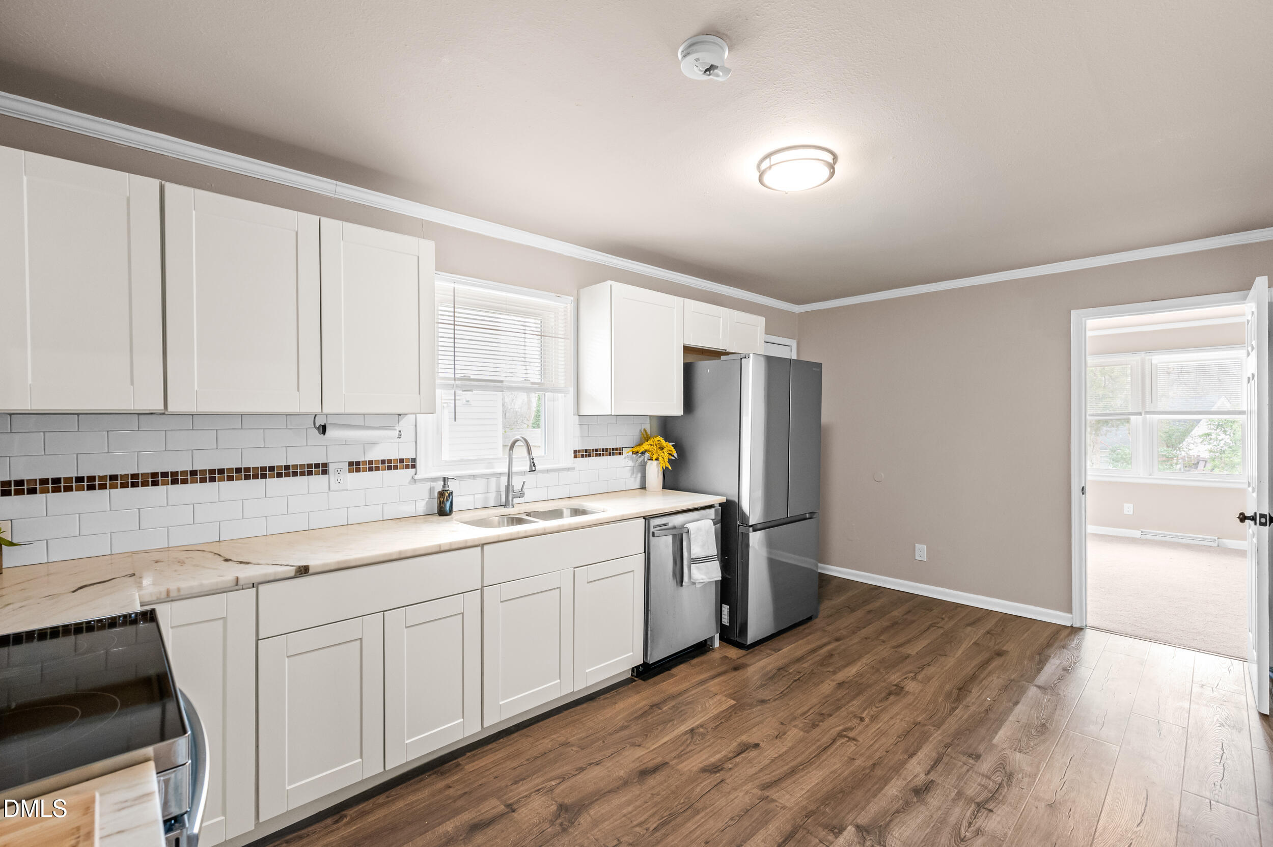 401 Moline Street Durham, NC 27707 - Photo 5 of 20 a kitchen with a sink stove and cabinets