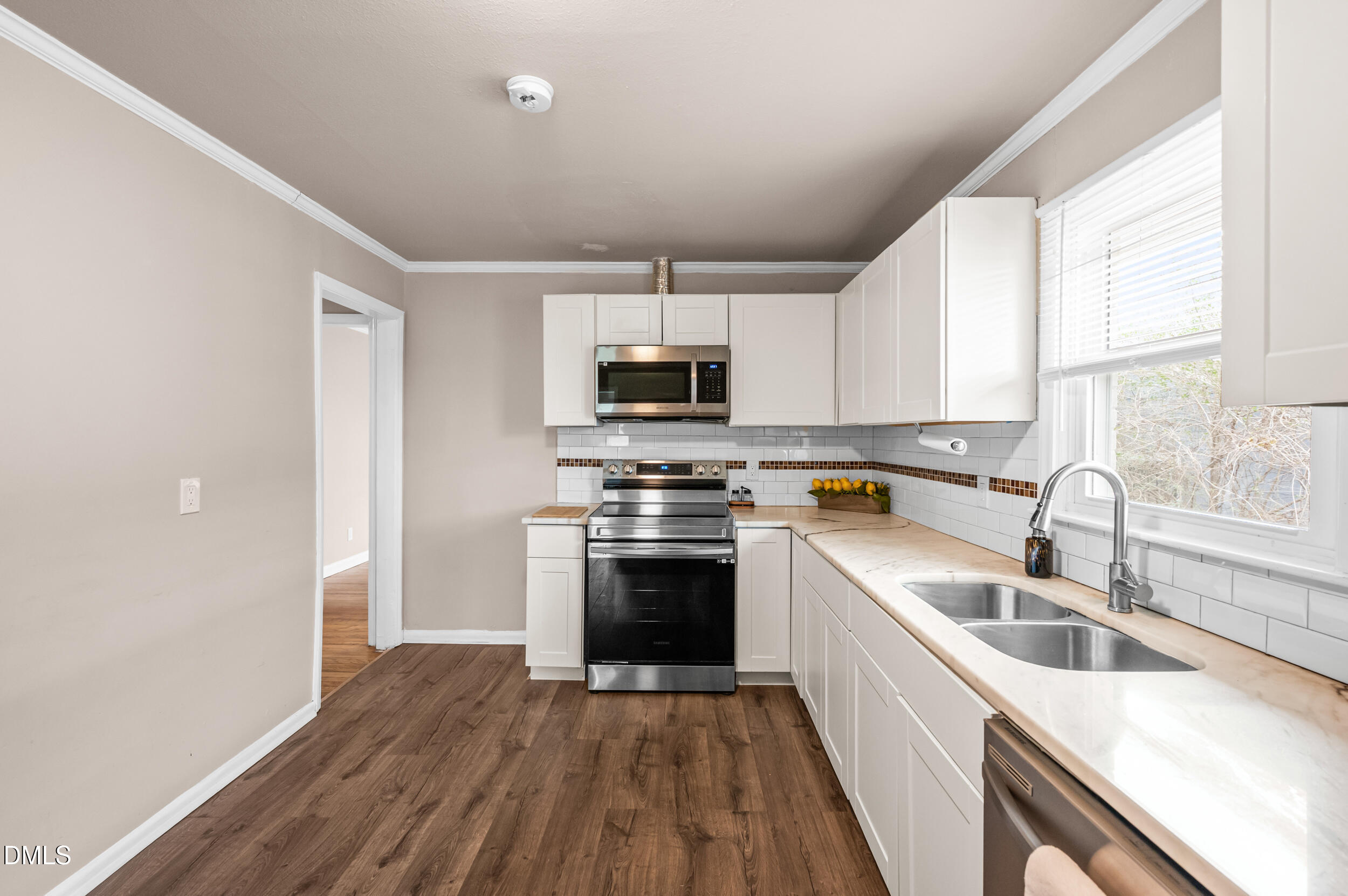 401 Moline Street Durham, NC 27707 - Photo 7 of 20 a kitchen with granite countertop a stove a sink and a microwave