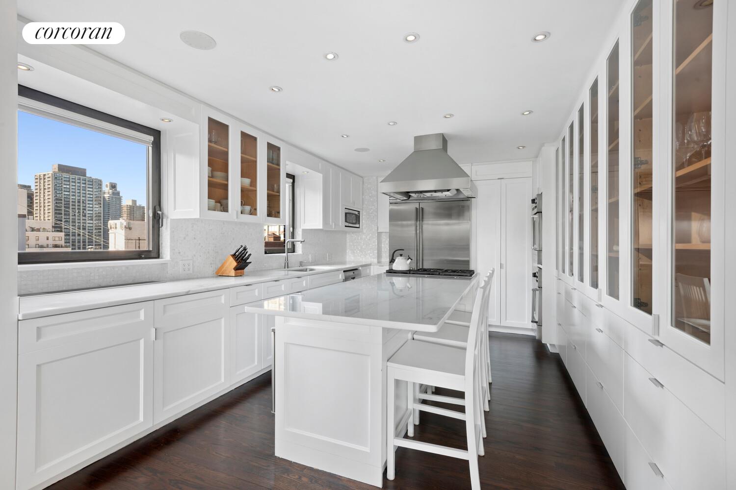 440 East 57th Street, Unit PH Manhattan, NY 10022 - Photo 7 of 18 a kitchen with white cabinets and sink