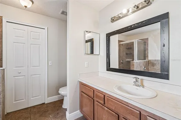 a bathroom with a sink a toilet and a mirror
