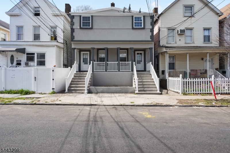 a front view of a house with a road