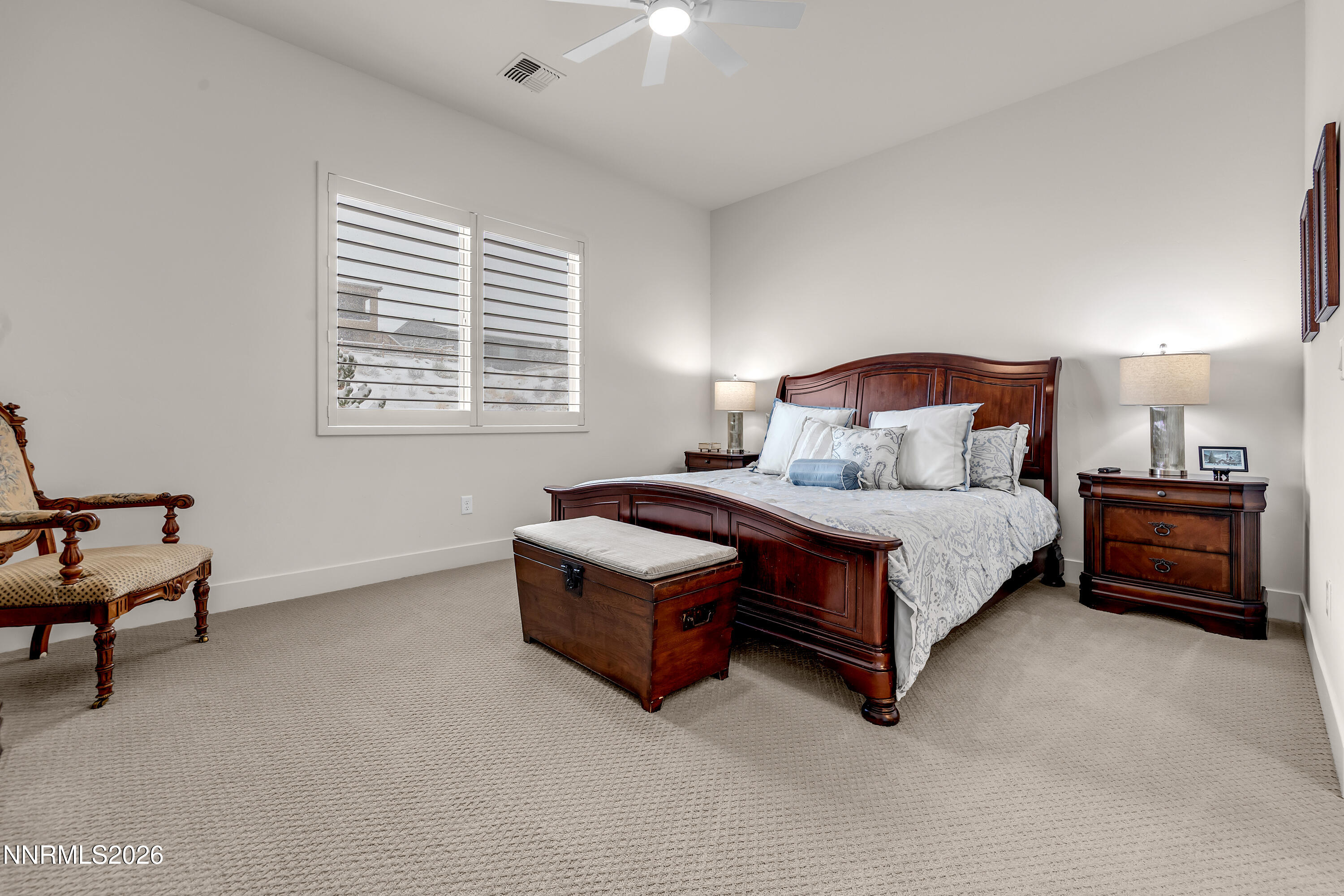 9109 Wild Skies Way Reno, NV 89523 - Photo 26 of 81 a bedroom with a bed and a lamp on desk