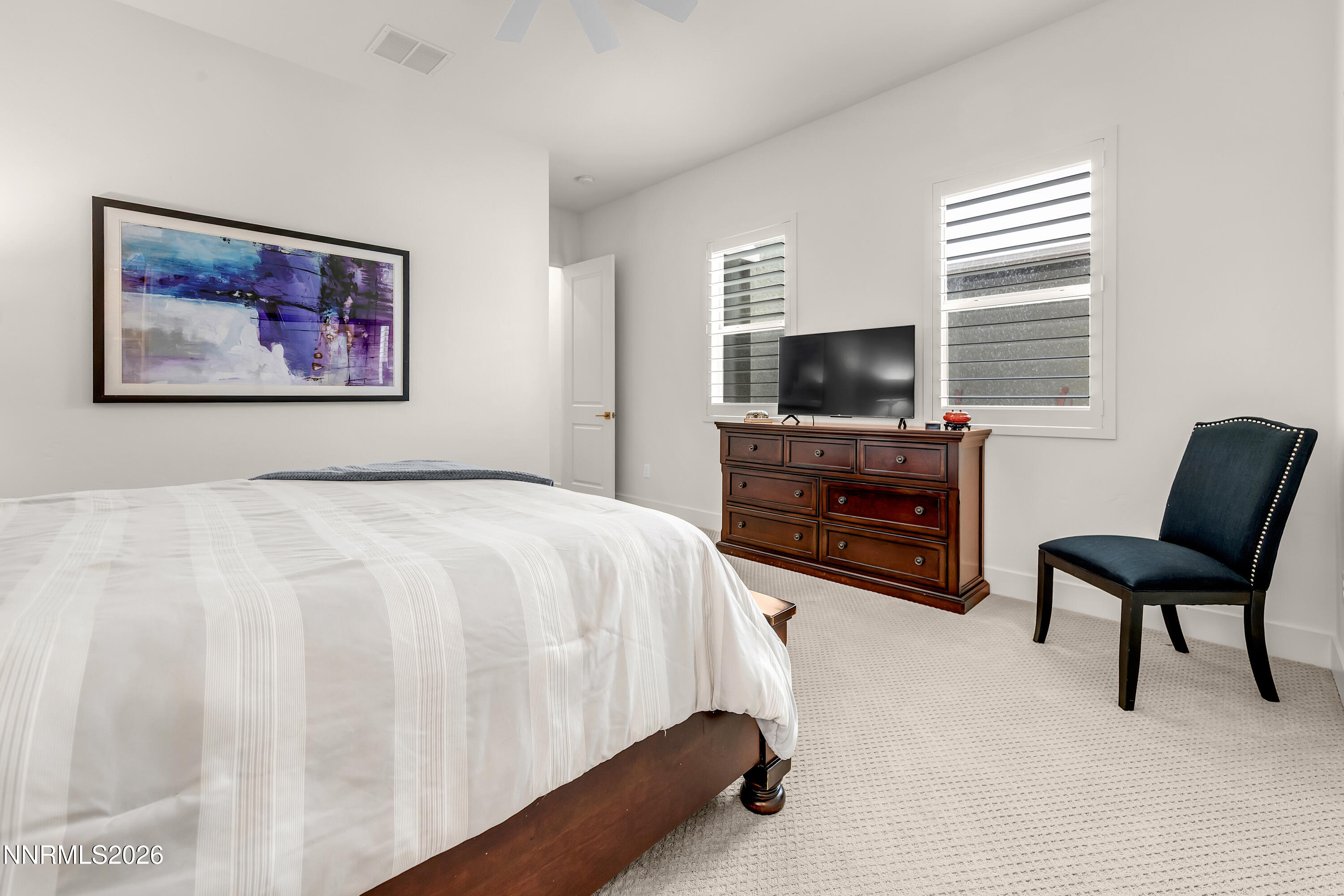 9109 Wild Skies Way Reno, NV 89523 - Photo 33 of 81 a bedroom with a bed and a flat screen tv