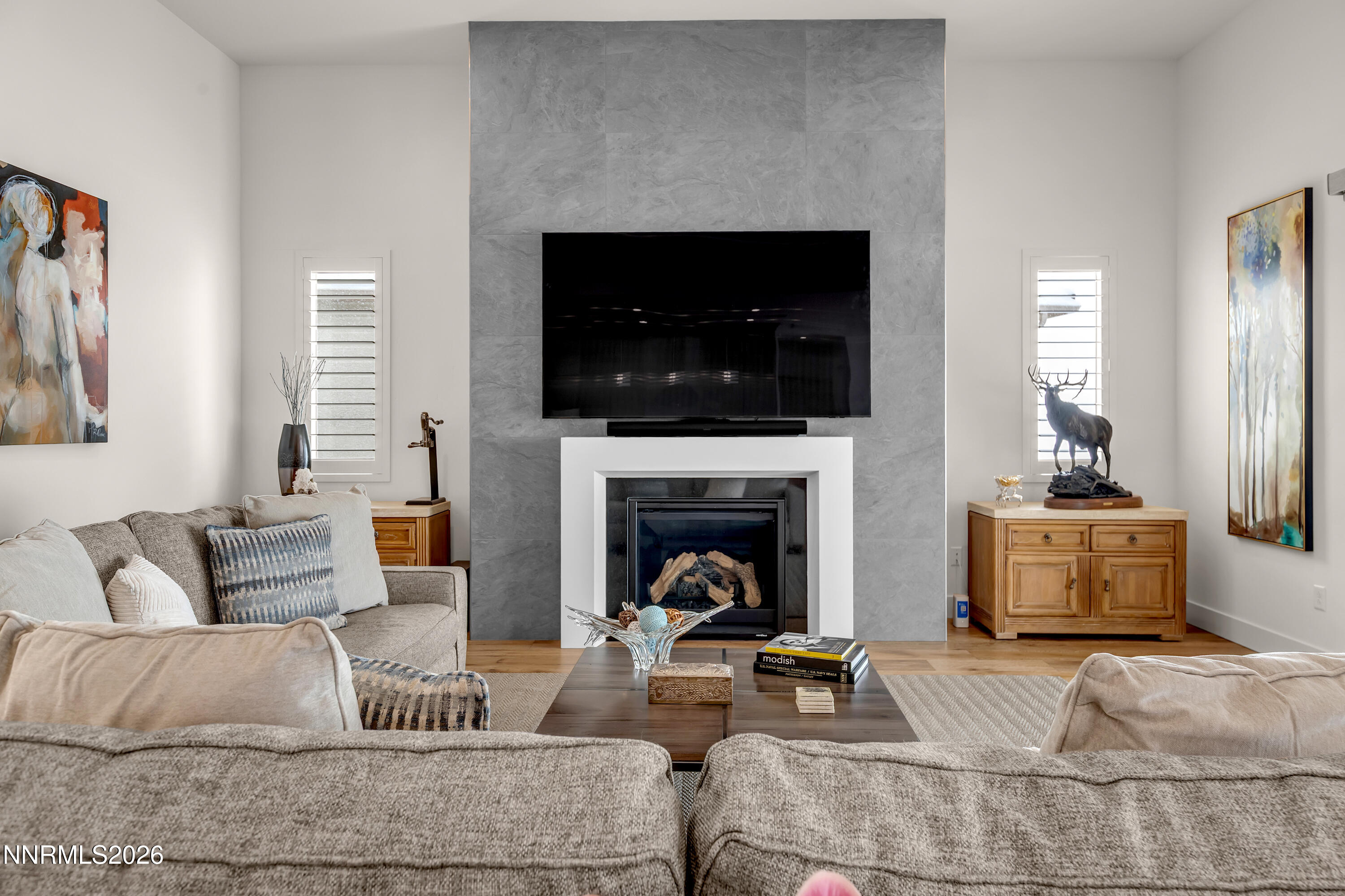 9109 Wild Skies Way Reno, NV 89523 - Photo 4 of 81 a living room with furniture a fireplace and a flat screen tv
