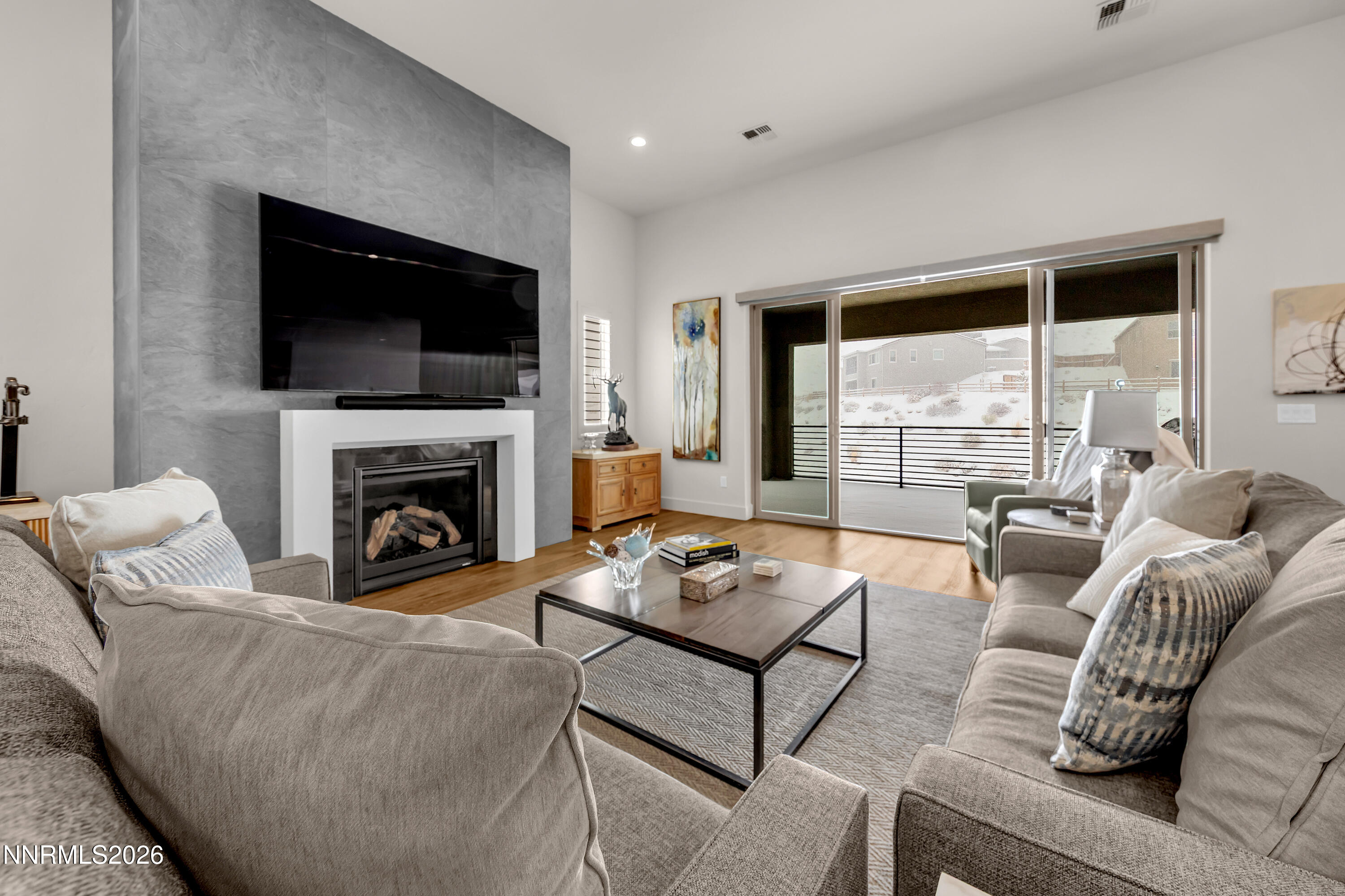 9109 Wild Skies Way Reno, NV 89523 - Photo 5 of 81 a living room with furniture a flat screen tv and a fireplace