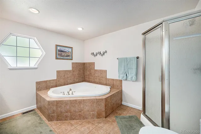 a bathroom with a tub and shower