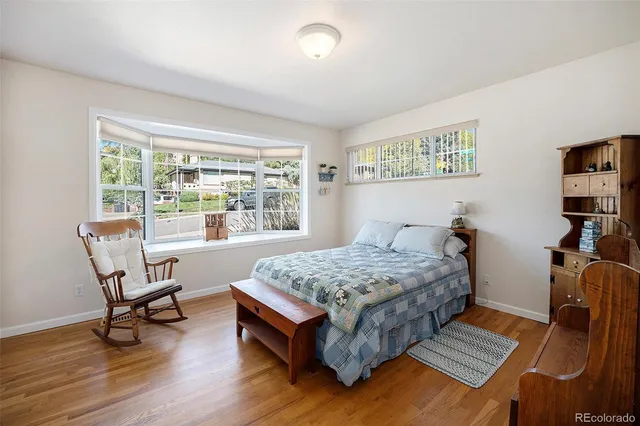 a bedroom with a bed and a desk