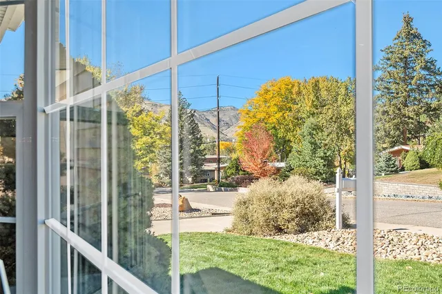 a view of a wooden chairs in patio with wooden fence