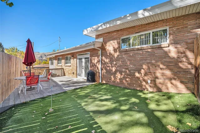 a view of backyard with deck and a garden